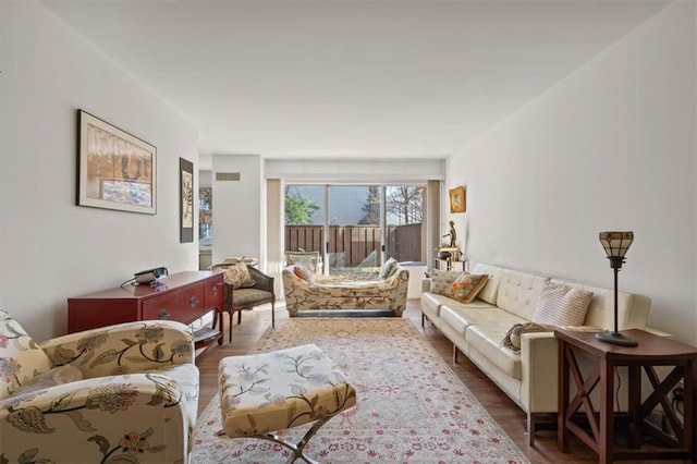 living room with wood finished floors and visible vents