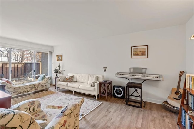 living room featuring baseboards and wood finished floors