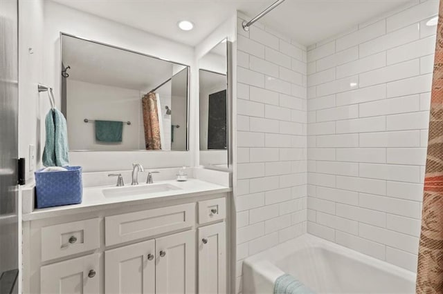 full bathroom featuring shower / bath combo with shower curtain and vanity