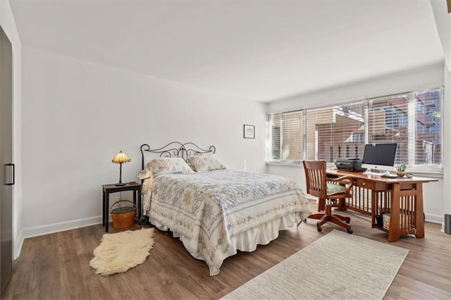 bedroom with wood finished floors and baseboards