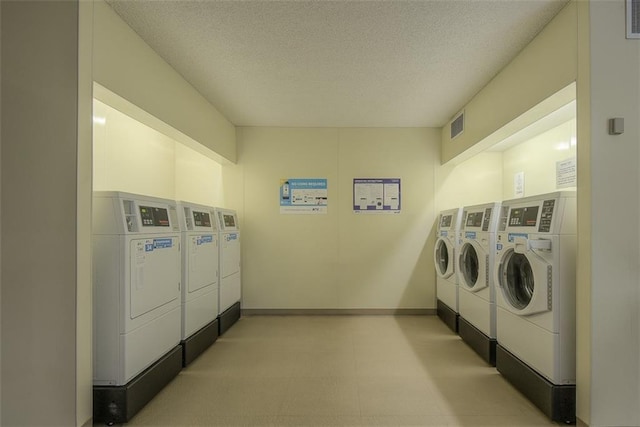 shared laundry area featuring visible vents, mail area, washer and dryer, a textured ceiling, and baseboards