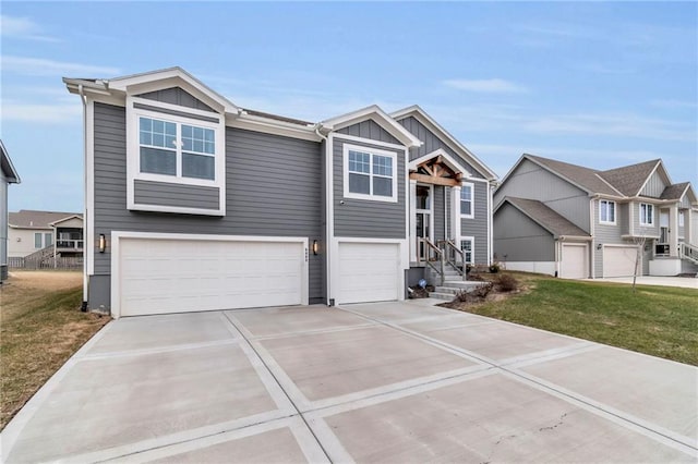 view of front of property featuring driveway, board and batten siding, an attached garage, and a front yard