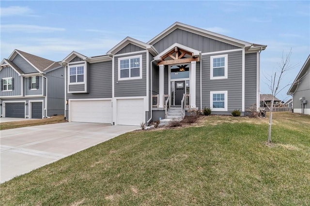 bi-level home featuring board and batten siding, concrete driveway, a front lawn, and an attached garage