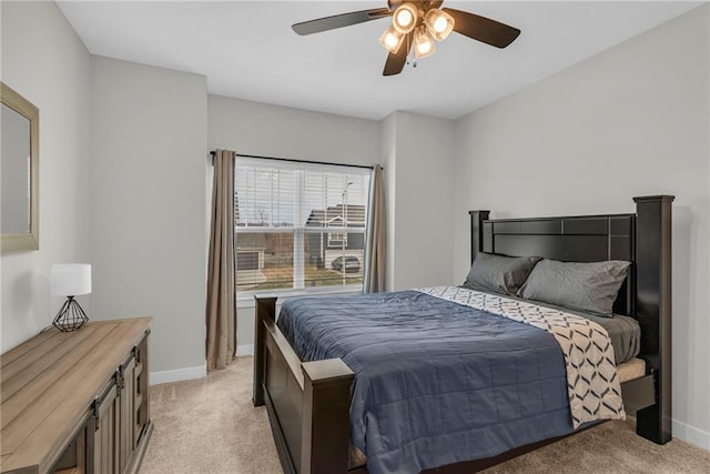 bedroom with baseboards, ceiling fan, and light colored carpet