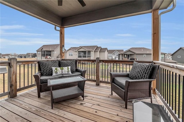 deck with ceiling fan, a residential view, and an outdoor hangout area