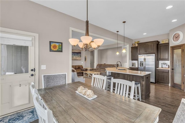 dining area featuring a chandelier, dark wood-style flooring, and recessed lighting