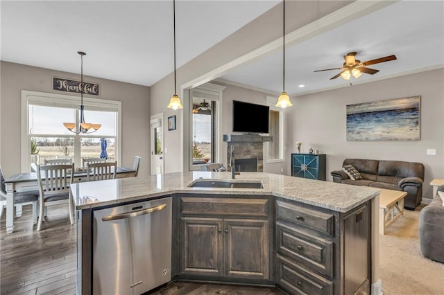 kitchen featuring open floor plan, stainless steel dishwasher, plenty of natural light, and a sink