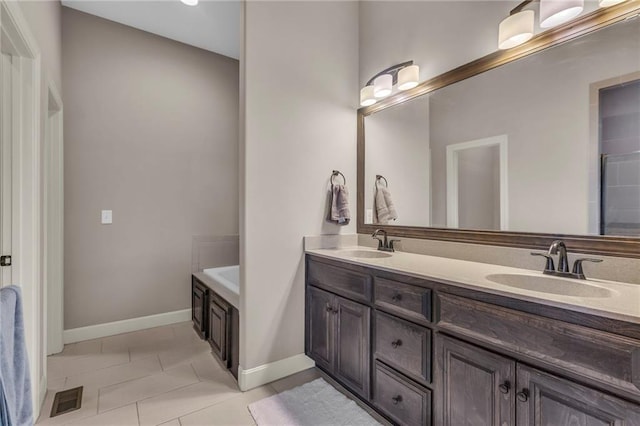 bathroom featuring double vanity, visible vents, a sink, and tile patterned floors