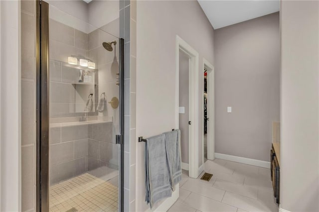 bathroom featuring a stall shower, baseboards, visible vents, and tile patterned flooring