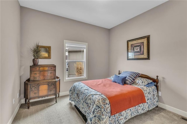 carpeted bedroom featuring baseboards