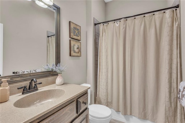 full bath with toilet, shower / tub combo with curtain, and vanity