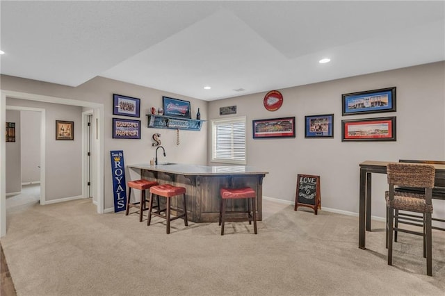 bar with light colored carpet, indoor wet bar, baseboards, and recessed lighting