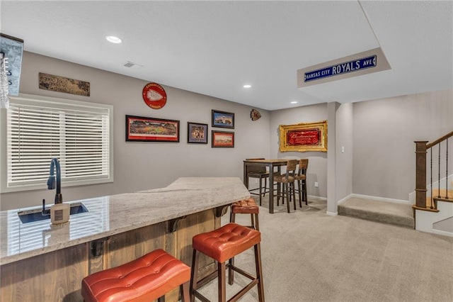 dining room featuring light carpet, stairs, baseboards, and recessed lighting