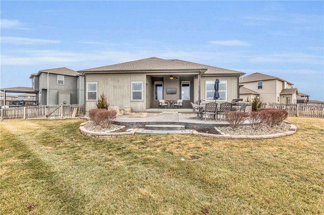 rear view of property with a patio area, fence, a ceiling fan, and a yard