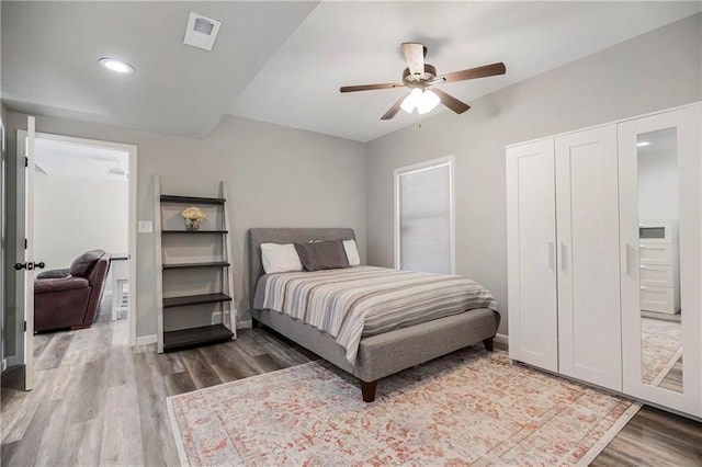 bedroom with baseboards, visible vents, a ceiling fan, wood finished floors, and recessed lighting