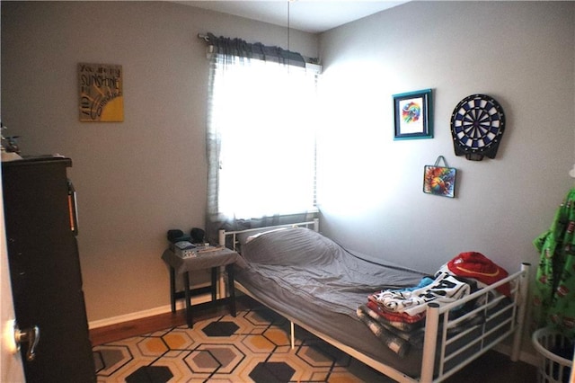 bedroom with multiple windows and baseboards