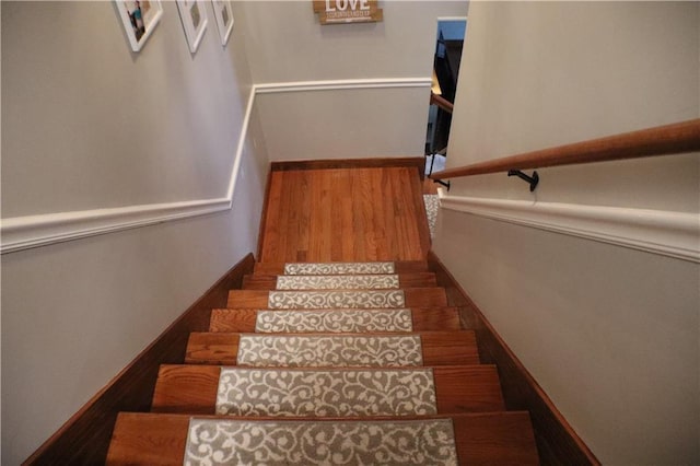 staircase with wood finished floors