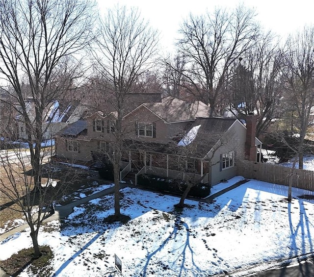 view of snow covered rear of property