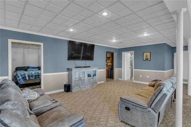 living area with ornate columns, carpet, baseboards, and recessed lighting