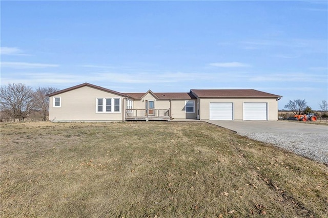 view of front facade with a front yard and a detached garage