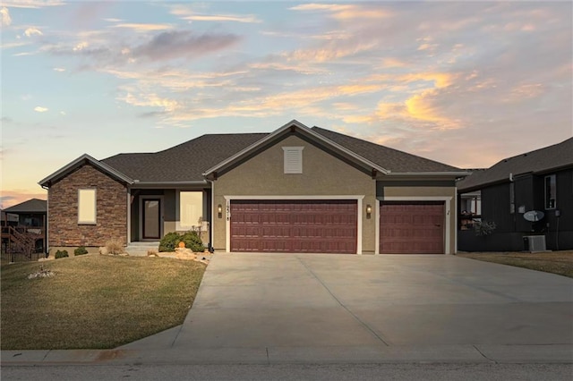 ranch-style house with stucco siding, an attached garage, driveway, and a yard