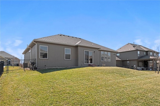 back of house featuring a yard and fence