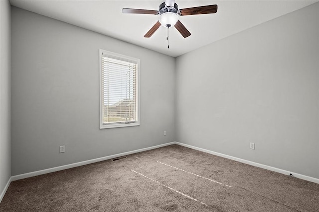 unfurnished room with visible vents, carpet floors, baseboards, and ceiling fan