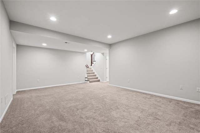 finished basement with carpet flooring, recessed lighting, stairs, and baseboards