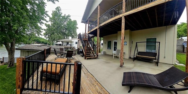 rear view of house with outdoor dining space, a patio area, and stairway