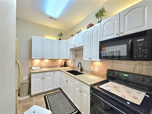 kitchen featuring black appliances, a sink, white cabinetry, and decorative backsplash