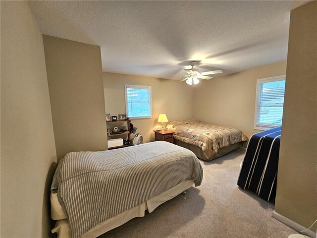 bedroom featuring carpet, ceiling fan, a textured ceiling, and baseboards