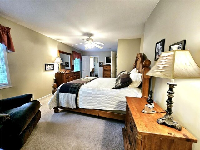 carpeted bedroom with a ceiling fan and baseboards