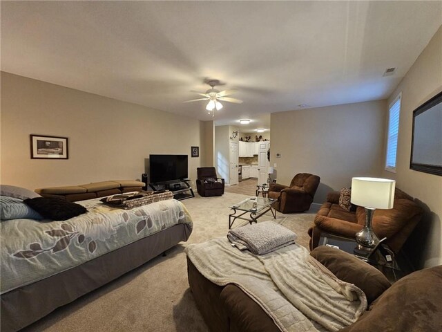 carpeted living room featuring visible vents and a ceiling fan