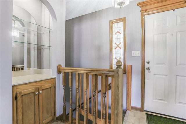 foyer entrance with light tile patterned flooring