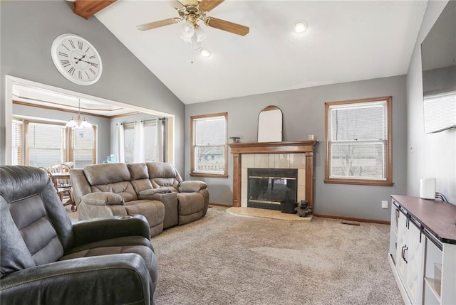 living room with beamed ceiling, light carpet, ceiling fan with notable chandelier, baseboards, and a tile fireplace