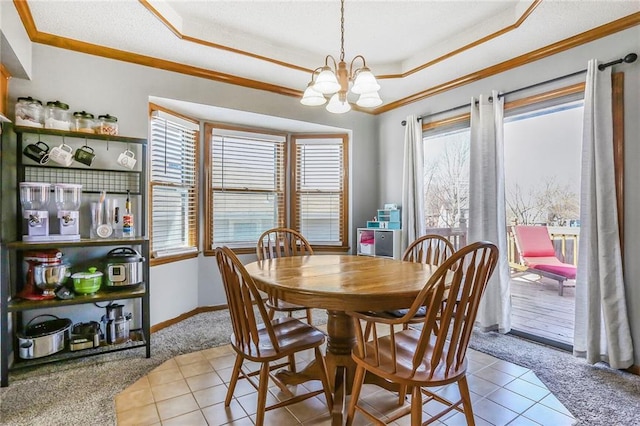 dining area featuring a tray ceiling, carpet flooring, and a wealth of natural light