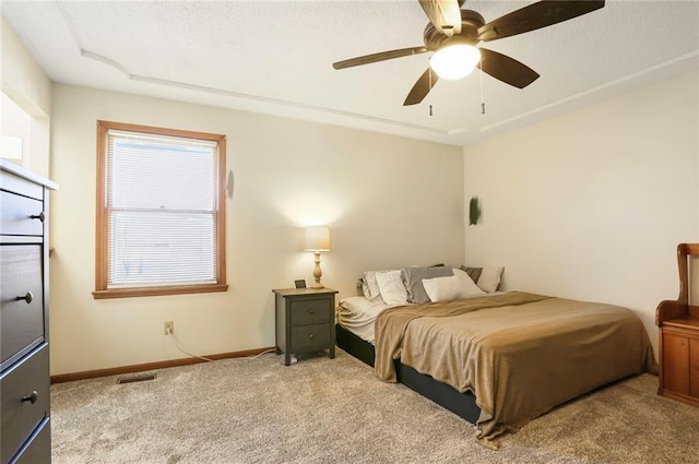 bedroom featuring visible vents, baseboards, carpet, and a ceiling fan