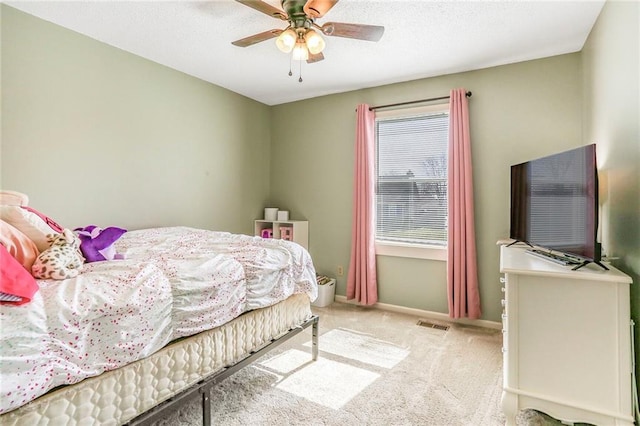 carpeted bedroom featuring visible vents, ceiling fan, a textured ceiling, and baseboards