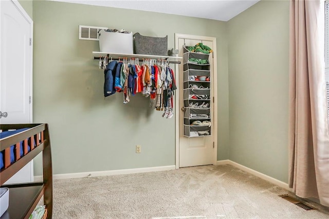 carpeted bedroom featuring visible vents and baseboards