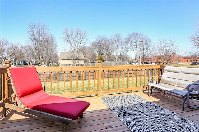 wooden deck featuring a yard and fence