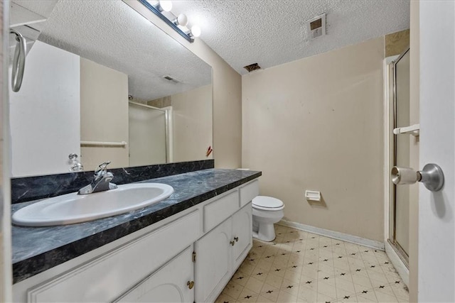 bathroom with a textured ceiling, vanity, visible vents, tile patterned floors, and a stall shower