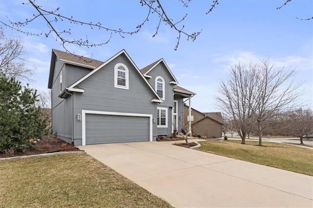 traditional-style home with driveway, a front lawn, and a garage