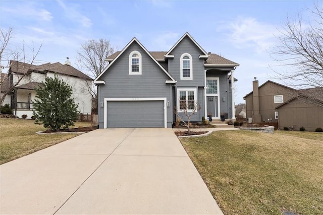 traditional home with a front yard, a garage, and driveway