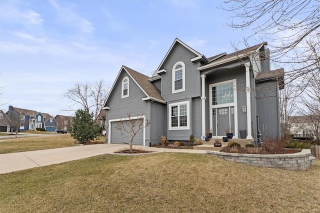 traditional home featuring a garage, concrete driveway, and a front lawn