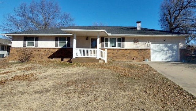 single story home featuring a garage, covered porch, brick siding, and driveway