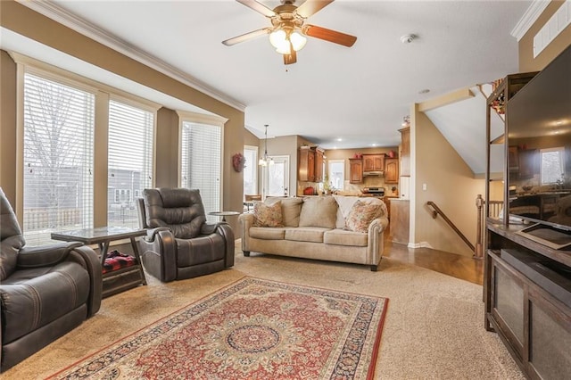 living room with ornamental molding and a ceiling fan