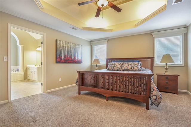 bedroom featuring a tray ceiling, visible vents, and light colored carpet