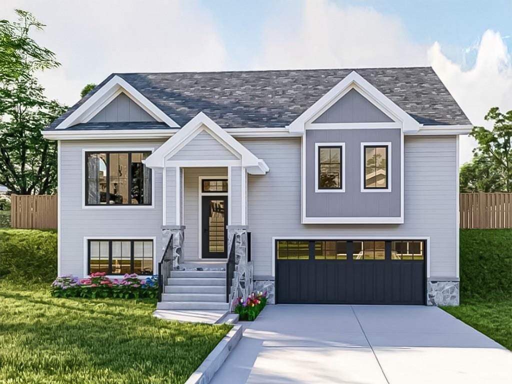 view of front of house with a front yard and a garage