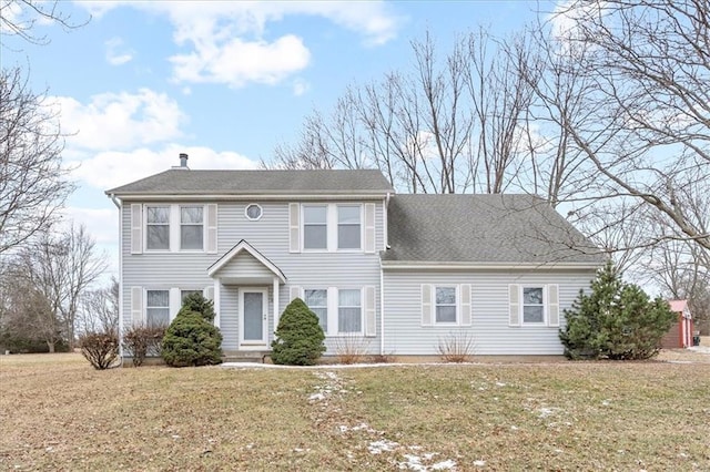 colonial house with a shingled roof and a front yard