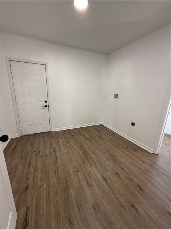 interior space featuring dark wood-style flooring and baseboards